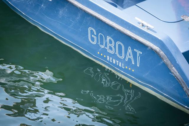 A rental boat from GoBoat is pictured on one of Copenhagen's canals in the Danish capital on July 23, 2021. From mid-June until late August, the CopenPay initiative offers around 100 activities, including motorboat rental company GoBoat, in exchange for free or reduced prices on a selection of experiences. (Photo by Emil Helms / Ritzau Scanpix / AFP) / Denmark OUT