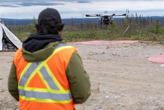Fast Forest employee Owen Lucas lands a drone that is used to plant tree seeds in Chibougamau, Quebec, Canada,  on June 19, 2025. Forests in Northern Quebec province were ravaged by wildfires in the summer of 2023 and for the second year in a row a pilot project has been using drones to plant new black spruces and jack pines. Rather than simply dropping seeds from high above, the company Flash Forest, which is leading the initiative, uses seeds protected in capsules that also contain water and nutrients, as well as fungi, to maximize their growing potential. (Photo by François Robert-Durand / AFP)