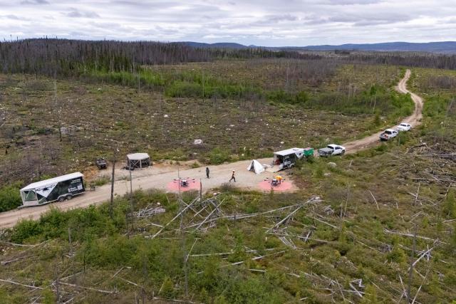 An aerial view of a site where the Flash Forest company plants tree seeds via done, in Chibougamau, Quebec, Canada, on June 19, 2025. Forests in Northern Quebec province were ravaged by wildfires in the summer of 2023 and for the second year in a row a pilot project has been using drones to plant new black spruces and jack pines. Rather than simply dropping seeds from high above, the company Flash Forest, which is leading the initiative, uses seeds protected in capsules that also contain water and nutrients, as well as fungi, to maximize their growing potential. (Photo by François Robert-Durand / AFP)