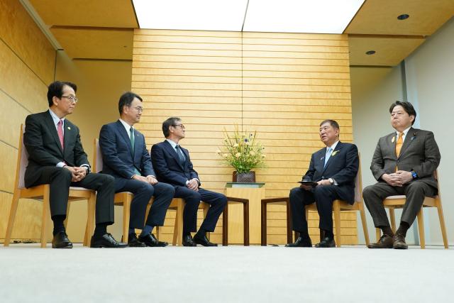 Japan's Prime Minister Shigeru Ishiba (2nd R), Chief Cabinet Secretary Yishimasa Hayashi (R) meet with Nippon Steel Corporation Chairman and CEO Eiji Hashimoto (3rd L), President and COO Tadashi Imai (2nd L), and Vice Chairman and Executive Vice President Takahiro Mori (L) at the prime minister's office in Tokyo on July 2, 2025. (Photo by Kazuhiro NOGI / POOL / AFP)