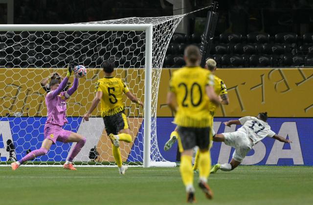 Borussia Dortmund's Swiss goalkeeper #01 Gregor Kobel makes a save past Monterrey's Mexican forward #17 Jesus Corona during the FIFA Club World Cup 2025 round of 16 football match between Germany's Borussia Dortmund and Mexico's Monterrey at the Mercedes-Benz Stadium in Atlanta on July 1, 2025. (Photo by Juan MABROMATA / AFP)