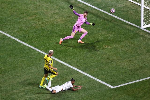 Borussia Dortmund's Swiss goalkeeper #01 Gregor Kobel makes a save past Monterrey's Mexican forward #17 Jesus Corona during the FIFA Club World Cup 2025 round of 16 football match between Germany's Borussia Dortmund and Mexico's Monterrey at the Mercedes-Benz Stadium in Atlanta on July 1, 2025. (Photo by Franck FIFE / AFP)