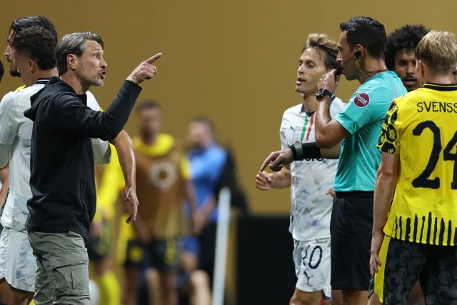Borussia Dortmund's Croatian head coach Niko Kovac argues with Argentine referee Facundo Tello during the FIFA Club World Cup 2025 round of 16 football match between Germany's Borussia Dortmund and Mexico's Monterrey at the Mercedes-Benz Stadium in Atlanta on July 1, 2025. (Photo by CHARLY TRIBALLEAU / AFP)