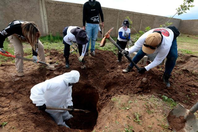 Members of the "Guerreros Buscadores" collective search human remains in a clandestine grave in Zapopan, Jalisco State, Mexico, on July 1, 2025, where the public prosecutor's office had concluded its search efforts. On June 26, Mexican authorities discovered the bodies of 34 people in a mass grave in a western region wracked by criminal violence, the state prosecutor's office said. The remains were found during construction work in Zapopan in Jalisco state, home to one of the country's most powerful drug cartels, prosecutor Salvador Gonzalez told a news conference. (Photo by AFP)