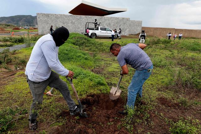 Members of the "Guerreros Buscadores" collective search human remains in a clandestine grave in Zapopan, Jalisco State, Mexico, on July 1, 2025, where the public prosecutor's office had concluded its search efforts. On June 26, Mexican authorities discovered the bodies of 34 people in a mass grave in a western region wracked by criminal violence, the state prosecutor's office said. The remains were found during construction work in Zapopan in Jalisco state, home to one of the country's most powerful drug cartels, prosecutor Salvador Gonzalez told a news conference. (Photo by AFP)