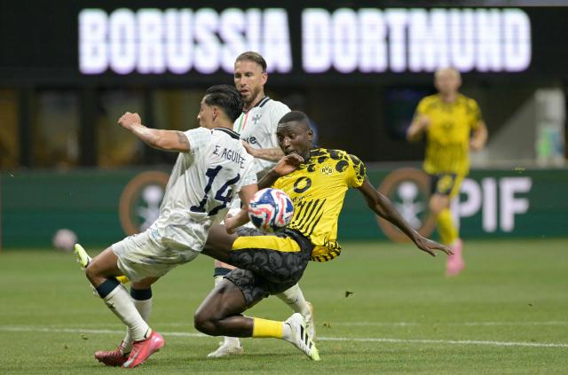 Monterrey's Mexican midfielder #14 Erick Aguirre (L) and Borussia Dortmund's Guinean forward #09 Serhou Guirassy (R) fight for the ball during the FIFA Club World Cup 2025 round of 16 football match between Germany's Borussia Dortmund and Mexico's Monterrey at the Mercedes-Benz Stadium in Atlanta on July 1, 2025. (Photo by JUAN MABROMATA / AFP)