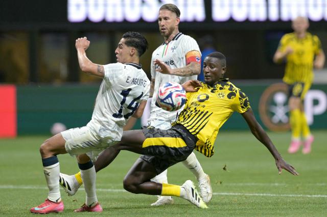 Monterrey's Mexican midfielder #14 Erick Aguirre (L) and Borussia Dortmund's Guinean forward #09 Serhou Guirassy (R) fight for the ball during the FIFA Club World Cup 2025 round of 16 football match between Germany's Borussia Dortmund and Mexico's Monterrey at the Mercedes-Benz Stadium in Atlanta on July 1, 2025. (Photo by Juan MABROMATA / AFP)