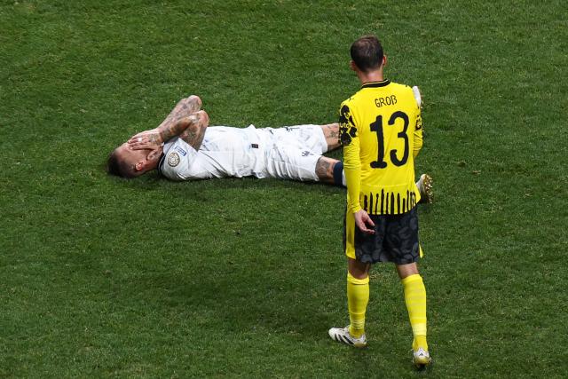 Monterrey's Spanish defender #93 Sergio Ramos reacts on the ground past Borussia Dortmund's German midfielder #13 Pascal Gross during the FIFA Club World Cup 2025 round of 16 football match between Germany's Borussia Dortmund and Mexico's Monterrey at the Mercedes-Benz Stadium in Atlanta on July 1, 2025. (Photo by Franck FIFE / AFP)