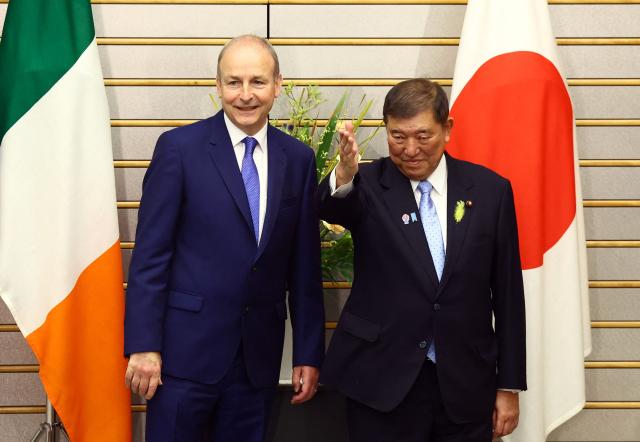 Japanese Prime Minister Shigeru Ishiba (R) gestures to Irish Prime Minister Micheal Martin before their summit talks at Ishiba's official residence in Tokyo on July 2, 2025. (Photo by ISSEI KATO / POOL / AFP)
