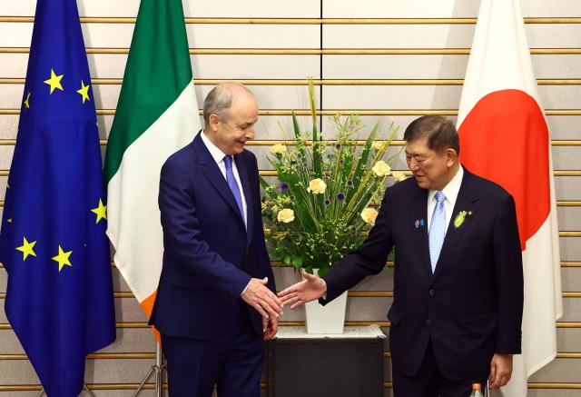 Japanese Prime Minister Shigeru Ishiba (R) shakes hands with Irish Prime Minister Micheal Martin before their summit talks at Ishiba's official residence in Tokyo on July 2, 2025. (Photo by ISSEI KATO / POOL / AFP)
