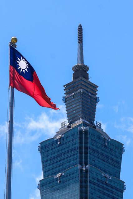 The Taiwan flag flutters in front of the Taipei 101 building in Taipei on July 2, 2025. (Photo by I-Hwa Cheng / AFP)
