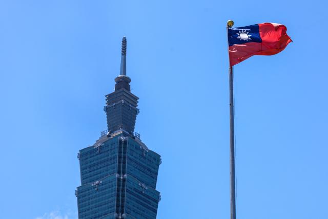 The Taiwan flag flutters in front of the Taipei 101 building in Taipei on July 2, 2025. (Photo by I-Hwa Cheng / AFP)