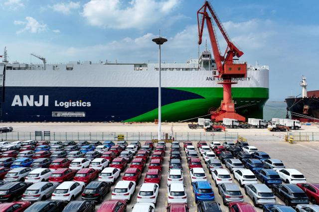 Chinese-made Morris Garages (MG) cars wait to be loaded onto the Chinese-made "Anji Commonality", a liquefied natural gas (LNG) dual-fuel pure car and truck carrier (PCTC) in Lianyungang, in eastern China's Jiangsu province on July 2, 2025. (Photo by AFP) / China OUT