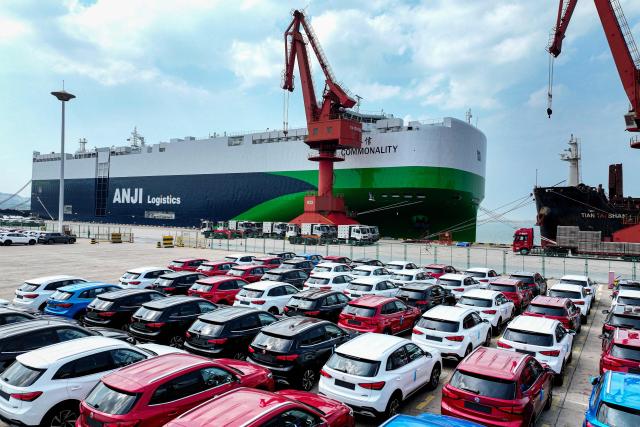 Chinese-made Morris Garages (MG) cars wait to be loaded onto the Chinese-made "Anji Commonality", a liquefied natural gas (LNG) dual-fuel pure car and truck carrier (PCTC) in Lianyungang, in eastern China's Jiangsu province on July 2, 2025. (Photo by AFP) / China OUT