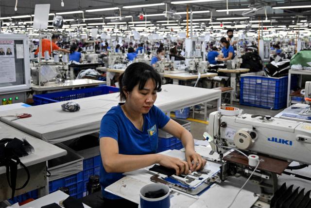 A worker stitches apparels at a garment factory in Vietnam's Thai Nguyen Province on July 2, 2025. Vietnam, a global manufacturing hub dependent on exports, faces a potential "reciprocal tariff" hike from 10 to 46 percent without a US trade deal. (Photo by Nhac NGUYEN / AFP)