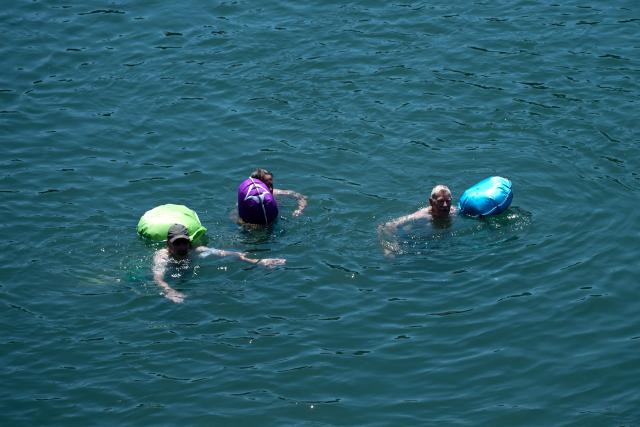 People swim into the Rhine River in Basel on July 2, 2025, as a heatwave hits Europe. (Photo by Miguel MEDINA / AFP)