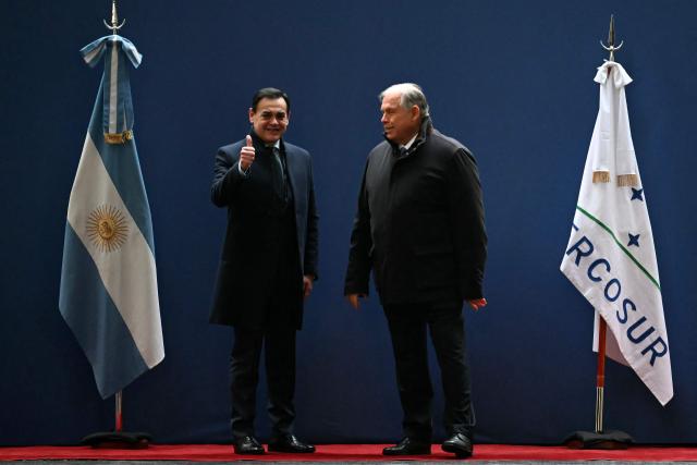 Paraguay's Foreign Minister Ruben Ramirez Lezcano (L) gives his thumb up next to Argentina's Foreign Minister Gerardo Werthein on arrival for the Ordinary Meeting of the Common Market Council (CMC) at the San Martin Palace in Buenos Aires on July 2, 2025, within the framework of the 66th Summit of Leaders of Mercosur and Associated States. Leaders of South America's Mercosur bloc will hold two days of talks in Buenos Aires, focused on a massive trade deal with the European Union being blocked by France. (Photo by Luis ROBAYO / AFP)