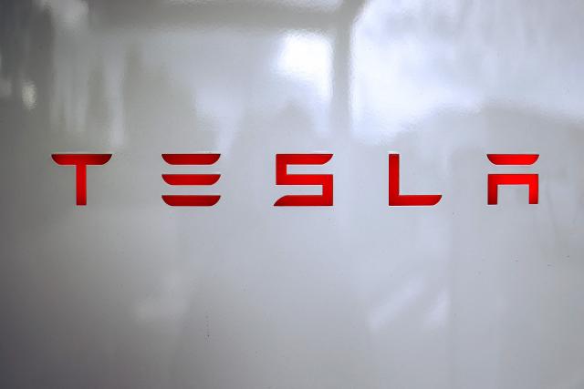 (FILES) A photo shows the Tesla logo on a charging station (Tesla Supercharger) in Chasse-sur-Rhone, central France, on June 6, 2025. Tesla reported another hefty drop in auto sales on July 2, 2025, extending a difficult period amid intensifying electric vehicle competition and backlash over CEO Elon Musk's political activities. (Photo by Alex MARTIN / AFP)