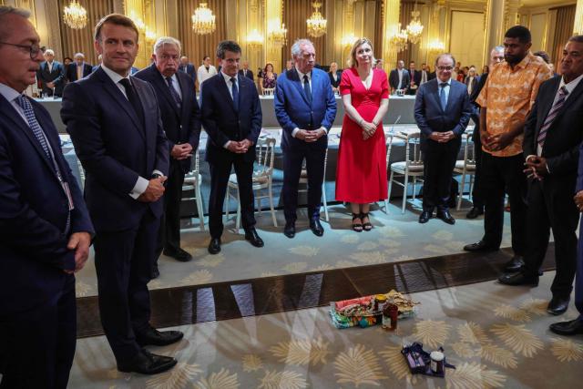 Private secretary of the French President Patrice Faure (L), France's President Emmanuel Macron, President of the French Senate Gerard Larcher, France's Minister of Overseas Manuel Valls, France's Prime Minister Francois Bayrou, President of the French National Assembly Yael Braun-Pivet attend with officials a custom ceremony inauguration a summit on New Caledonia at the Elysee Palace in Paris on July 2, 2025. After months of “patient work” and three return trips to New Caledonia, France's Minister of Overseas is hoping to reach a compromise between independentists and loyalists at the “summit” that begins on July 2. (Photo by Ludovic MARIN / POOL / AFP)