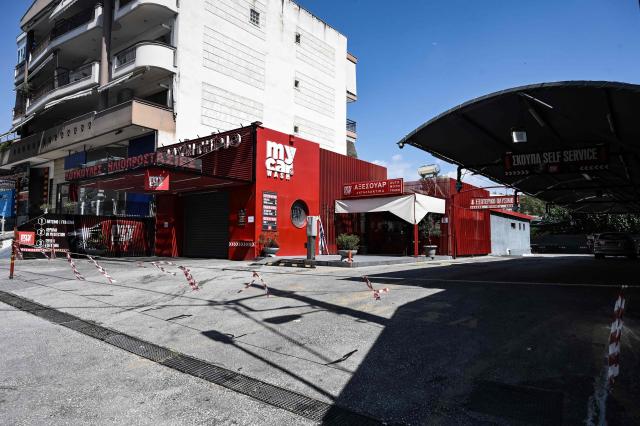 A car wash shop is closed during a strike in Thessaloniki on July 2, 2025. Car repair shops, car washes, parking facilities, and vehicle rental businesses across Greece have begun rolling 24-hour strikes in protest against the compulsory implementation of a new digital customer registry, which came into effect on July 1. (Photo by SAKIS MITROLIDIS / AFP)