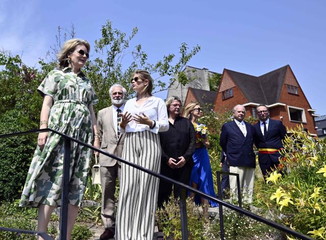 Queen Mathilde of Belgium (L) listens during a royal visit at the "Museum & Gardens van Buuren" in Uccle, an Art Deco museum on July 2, 2025. To mark its 50th anniversary and the 100th anniversary of the birth of the Art Deco movement, the museum is hosting an exhibition entitled "Around Art Deco," dedicated to interwar sculpture. (Photo by ERIC LALMAND / Belga / AFP) / Belgium OUT