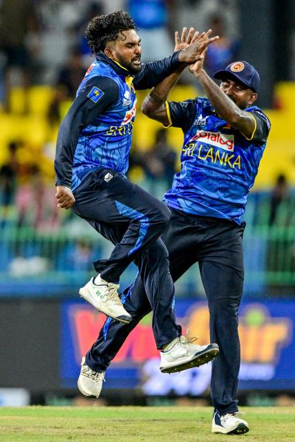 Sri Lanka's Wanindu Hasaranga (L) celebrates with a teammate after taking the wicket of Bangladesh's captain Mehidy Hasan Miraz during the first one-day international (ODI) cricket match between Sri Lanka and Bangladesh at the R. Premadasa International Cricket Stadium in Colombo on July 2, 2025. (Photo by Ishara S. KODIKARA / AFP)