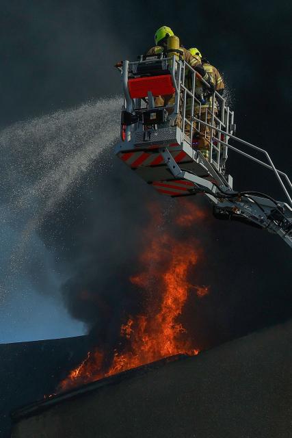 Members of the fire brigade work to extinguish a blaze at a apartment building in Berlin on July 2, 2025. (Photo by Odd ANDERSEN / AFP) / ALTERNATIVE CROP
