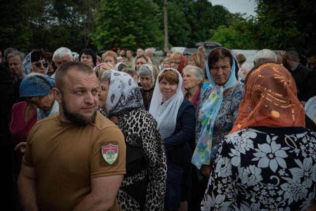 Believers attend a consecration ceremony of a newly built church in the village of Koviagy, Kharkiv region, on July 2, 2025, amid the Russian invasion of Ukraine. (Photo by Ivan SAMOILOV / AFP)