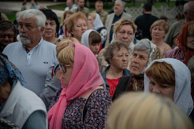 Believers attend a consecration ceremony of a newly built church in the village of Koviagy, Kharkiv region, on July 2, 2025, amid the Russian invasion of Ukraine. (Photo by Ivan SAMOILOV / AFP)