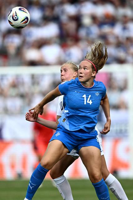 Finland's midfielder #20 Eveliina Summanen fights for the ball with Iceland's forward #14 Hlin Eiriksdottir during the UEFA Women's Euro 2025 Group A football match between Iceland and Finland at the Arena Thun stadium in Thun on July 2, 2025.  (Photo by Fabrice COFFRINI / AFP)