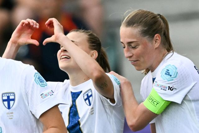 Finland's midfielder #09 Katariina Kosola (L) celebrates after she scored her team's first goal during the UEFA Women's Euro 2025 Group A football match between Iceland and Finland at the Arena Thun stadium in Thun on July 2, 2025.  (Photo by Fabrice COFFRINI / AFP)