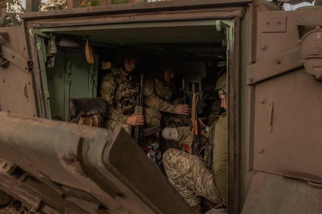 (FILES) Ukrainian soldiers with their weapons sitting inside a US-made M113 armoured personnel carrier depart for the front in an undisclosed area, in the eastern Donetsk region, on August 5, 2024, amid the Russian invasion of Ukraine. Ukraine appealed to the United States for clarity on July 1, 2025, after it was caught off guard by a White House announcement that Washington was halting some arms shipments to the war-battered country. The White House had said that it was halting some key weapons shipments promised by the previous US administration, without elaborating. (Photo by Roman PILIPEY / AFP)