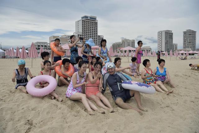 Domestic tourists visit the beach at Wonsan Kalma Coastal Tourist Area in Wonsan, North Korea's Kangwon Province on July 2, 2025. North Korea opened a massive resort area on its east coast, state media said on July 2, with the tourism pet project of leader Kim Jong Un reportedly set to welcome Russian guests later this month. (Photo by KIM Won Jin / AFP)