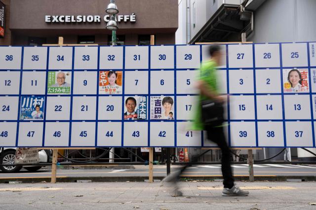A man walks past an election poster bulletin board ahead of the July 20 upper house election in Tokyo on July 3, 2025. (Photo by Yuichi YAMAZAKI / AFP)