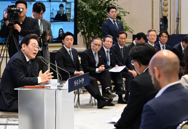 South Korean President Lee Jae Myung (L) delivers a speech during a press conference to mark his first 30 days in office at the Blue House in Seoul on July 3, 2025. (Photo by KIM Min-Hee / POOL / AFP)