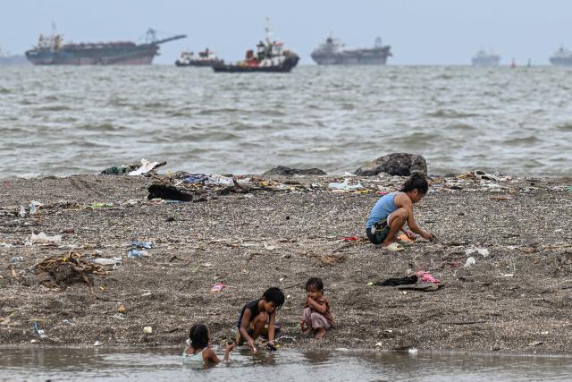 Children play along Manila Bay on July 3, 2025. (Photo by Jam STA ROSA / AFP)