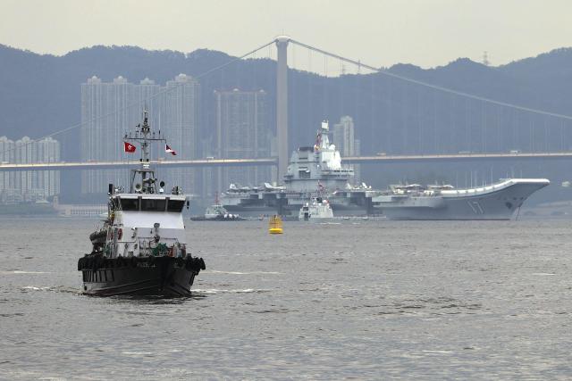 China's first domestically built aircraft carrier Shandong is anchored after arriving in Hong Kong on July 3, 2025. Commissioned in 2019, the 305-metre-long (1,000 feet) Shandong is China's second carrier and key to the country's regional ambitions under President Xi Jinping, who oversaw a massive naval buildup that has rattled Asian neighbours. (Photo by May JAMES / AFP)