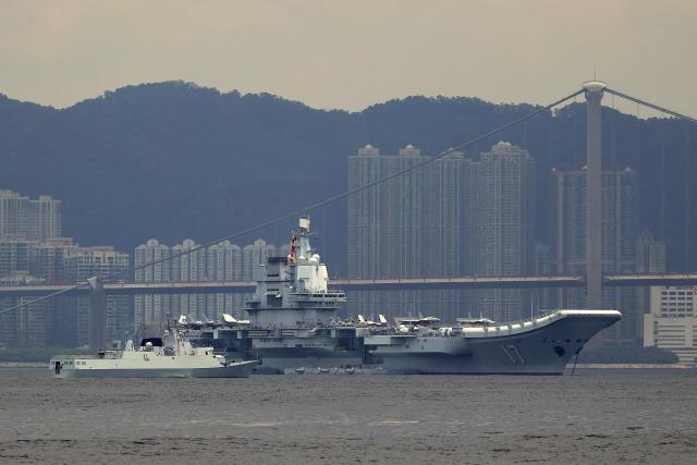 China's first domestically built aircraft carrier Shandong is anchored after arriving in Hong Kong on July 3, 2025. Commissioned in 2019, the 305-metre-long (1,000 feet) Shandong is China's second carrier and key to the country's regional ambitions under President Xi Jinping, who oversaw a massive naval buildup that has rattled Asian neighbours. (Photo by May JAMES / AFP)