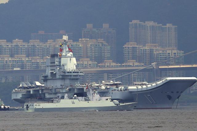 China's first domestically built aircraft carrier Shandong is anchored after arriving in Hong Kong on July 3, 2025. Commissioned in 2019, the 305-metre-long (1,000 feet) Shandong is China's second carrier and key to the country's regional ambitions under President Xi Jinping, who oversaw a massive naval buildup that has rattled Asian neighbours. (Photo by May JAMES / AFP)