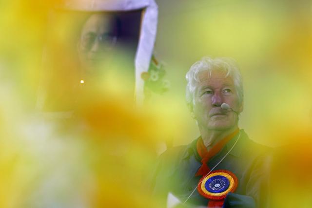US actor Richard Gere sits next to a portrait of the Tibetan spiritual leader the Dalai Lama during the International Tibet Youth Forum in Dharamsala on July 3, 2025. The Dalai Lama said on July 2 that the 600-year-old Tibetan spiritual institution would continue after his death, reassuring Buddhist followers around the globe and saying his office "exclusively" would name his successor, even as China insisted it would. (Photo by Niharika KULKARNI / AFP)