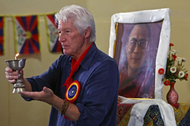 US actor Richard Gere lights a lamp in honour of the Tibetan spiritual leader the Dalai Lama during the International Tibet Youth Forum in Dharamsala on July 3, 2025. The Dalai Lama said on July 2 that the 600-year-old Tibetan spiritual institution would continue after his death, reassuring Buddhist followers around the globe and saying his office "exclusively" would name his successor, even as China insisted it would. (Photo by Niharika KULKARNI / AFP)
