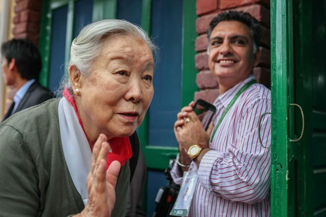 Tibetan spiritual leader the Dalai Lama's younger sister Jetsun Pema (L) waves to people as she arrives to attend the International Tibet Youth Forum in Dharamsala on July 3, 2025. The Dalai Lama said on July 2 that the 600-year-old Tibetan spiritual institution would continue after his death, reassuring Buddhist followers around the globe and saying his office "exclusively" would name his successor, even as China insisted it would. (Photo by Niharika KULKARNI / AFP)