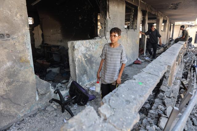 A boy checks the destruction at Mustafa Hafez school, sheltering Palestinians displaced by the war, following an overnight Israeli strike in Gaza City, on July 3, 2025, amid the ongoing conflict between Israel and the Palestinian Hamas militant group. (Photo by Omar AL-QATTAA / AFP)