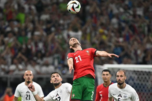 (FILES) Portugal's forward #21 Diogo Jota jumps to head the ball during the UEFA Euro 2024 round of 16 football match between Portugal and Slovenia at the Frankfurt Arena in Frankfurt am Main on July 1, 2024. Liverpool striker Diogo Jota died along with his brother early July 3, 2025 in a road accident in northwest Spain, the Spanish Civil Guard said. The accident occurred around 12:30 a.m. on a highway in the province of Zamora. The vehicle "left the road" before bursting into flames, the Civil Guard said, adding that the two passengers, Diogo Jota and his brother Andre Felipe, also a professional footballer, were deceased. (Photo by JAVIER SORIANO / AFP)