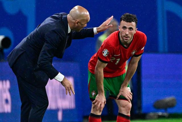 (FILES) Portugal's head coach Roberto Martinez (L) speaks to Portugal's forward #21 Diogo Jota during the UEFA Euro 2024 Group F football match between Portugal and the Czech Republic at the Leipzig Stadium in Leipzig on June 18, 2024. Liverpool striker Diogo Jota died along with his brother early July 3, 2025 in a road accident in northwest Spain, the Spanish Civil Guard said. The accident occurred around 12:30 a.m. on a highway in the province of Zamora. The vehicle "left the road" before bursting into flames, the Civil Guard said, adding that the two passengers, Diogo Jota and his brother Andre Felipe, also a professional footballer, were deceased. (Photo by JOHN MACDOUGALL / AFP)