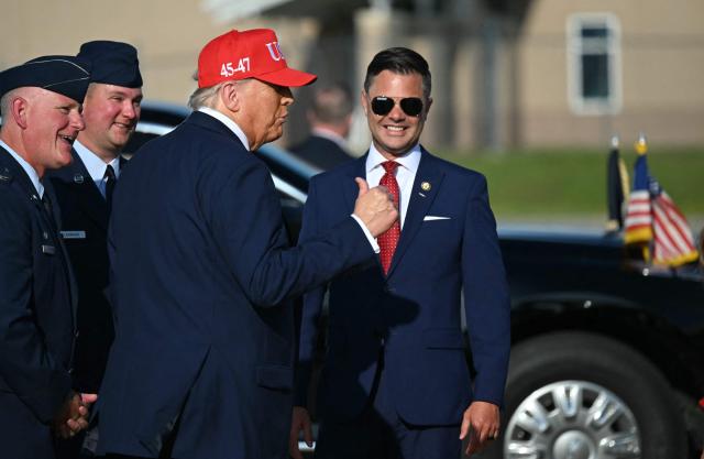 US President Donald Trump gestures as US representative Zach Nunn (R-IO) after landing at Des Moines International Airport, Iowa on July 3, 2025. Trump is in Iowa to participate in the Salute to America Celebration. (Photo by ANDREW CABALLERO-REYNOLDS / AFP)