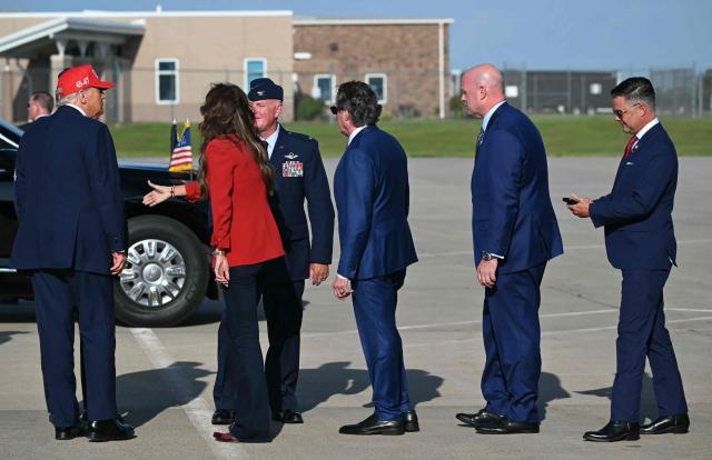 US President Donald Trump (L) followed by US Secretary of Homeland Security Kristi Noem (2L), US Secretary of the Interior Doug Burgum (C) and officials walk on the tarmac after landing at Des Moines International Airport, Iowa on July 3, 2025. Trump is in Iowa to participate in the Salute to America Celebration. (Photo by ANDREW CABALLERO-REYNOLDS / AFP)