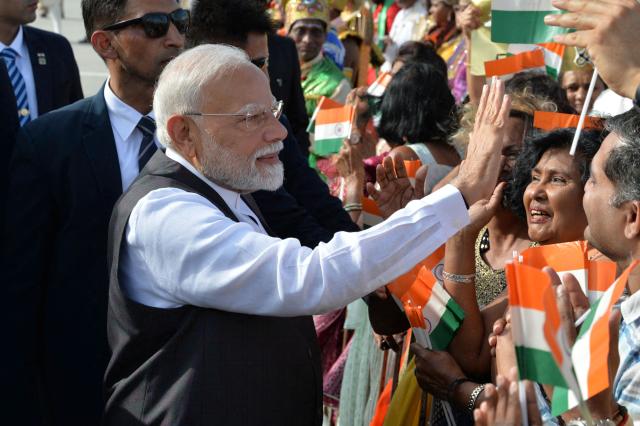 India Prime Minister Prime Minister Narendra Modi greets supporters after arrival at Piarco International Airport in Port of Spain, Trinidad and Tobago on July 3, 2025. Indian Prime Minister Narendra Modi on Thursday began a two-day visit to Trinidad and Tobago, where just over 35% of the population is of Indian descent. (Photo by Robert Taylor / AFP)