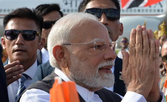 India Prime Minister Prime Minister Narendra Modi greets supporters after arrival at Piarco International Airport in Port of Spain, Trinidad and Tobago on July 3, 2025. Indian Prime Minister Narendra Modi on Thursday began a two-day visit to Trinidad and Tobago, where just over 35% of the population is of Indian descent. (Photo by Robert Taylor / AFP)
