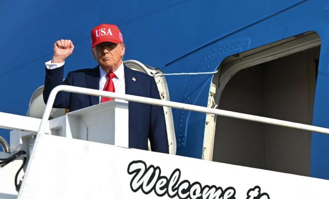 US President Donald Trump steps off Air Force One as he arrives at Des Moines International Airport, Iowa on July 3, 2025. Trump is in Iowa to participate in the Salute to America Celebration. (Photo by ANDREW CABALLERO-REYNOLDS / AFP) / ALTERNATE CROP